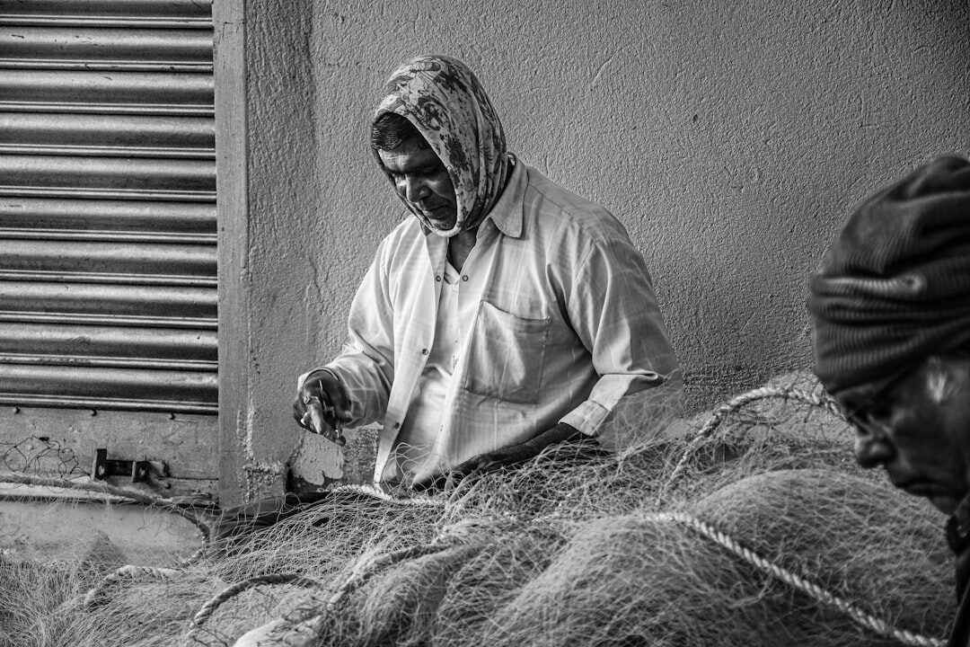 fishermen repairing nets
